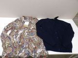 pair of men ' s shirts on a white table in a room