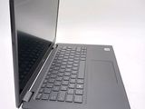 a laptop that is open on a white surface