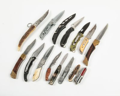 many different types of knives on a white surface