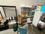 a man that is standing in a room with many items