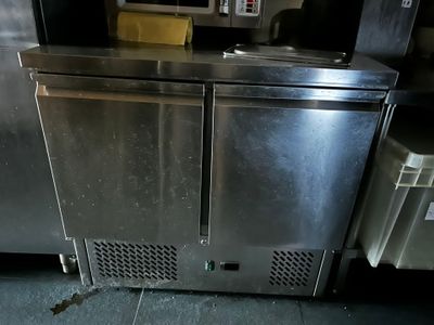 a stainless steel refrigerator in a commercial kitchen
