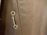 a close up of a brown leather purse with a key on it