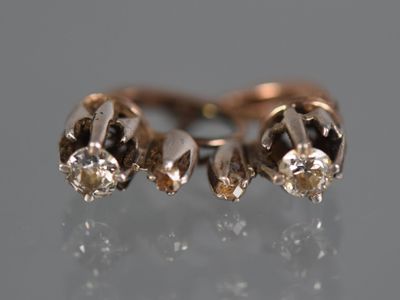 a close up of a diamond ring on a reflective surface