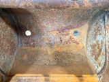 a close up of a rusted metal structure with a hole in the middle