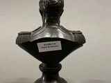 statue of a bust of a man on a pedestal with a label on it