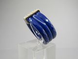 a close up of a blue bracelet on a clear stand
