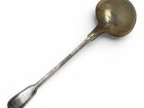 a spoon with a spoon rest on it on a white surface