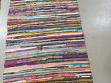 two colorful rugs on the floor in a room