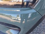 a reflection of a person in a car ' s rear window