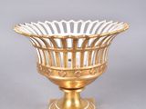an image of a gold and white bowl on a stand