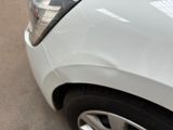 a close up of a car ' s headlight and the front end of the car