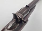 an old gun with a wooden handle on a white background