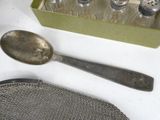 a box of salt and pepper shakers next to a silver spoon and strainer