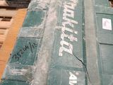 a green box sitting on top of a wooden pallet