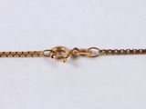 a close up of a gold chain with a skull on it