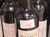 many bottles of wine sitting on a shelf in a store