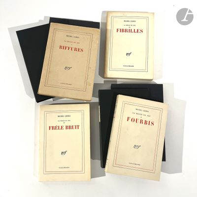 four books are stacked on top of each other on a white surface