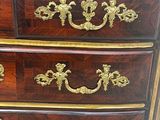 an image of a chest of drawers with gold decoration