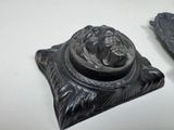 two pieces of art that are sitting on a table