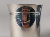 a silver cup with a picture of a woman on it