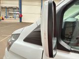 someone is taking a picture of their reflection in the side view mirror of a car