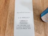 a bottle of skinceuticals sitting on a table next to a tube of cream