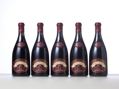 four bottles of wine lined up on a table