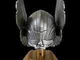 a close up of a helmet with wings on a stand