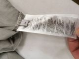 a person holding a piece of paper that has a label on it