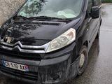a small black van parked on the side of the road