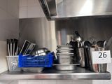 many pots and pans on the shelf in the kitchen