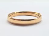 a close up of a gold ring on a white surface