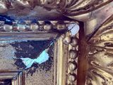 a picture of a mirror with a gold frame on it