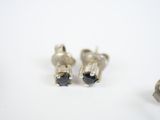 pair of black diamond stud earrings on a white surface