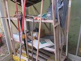 a small shed with a shovel and a rake in it