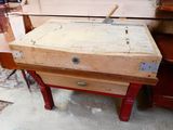 a wooden box with a hammer on it sitting on a table
