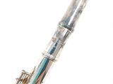 a silver and blue pen sitting on top of a white table
