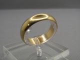 a gold ring sitting on top of a clear display case
