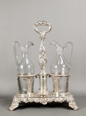 an image of a silver plated table with two vases and a candle holder
