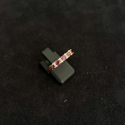 pink and white diamond ring on a black surface