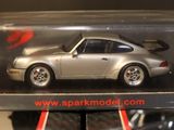 a model of a silver car in a clear box