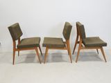 three chairs with upholstered seats in a white room