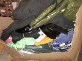 a cardboard box full of clothes and shoes in it