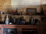 a wooden cabinet with many bottles on top of it
