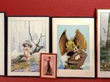 four framed pictures on the wall of a red room