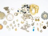 many different types of jewelry on a white surface