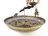 a person that is holding a bowl with a bird on it