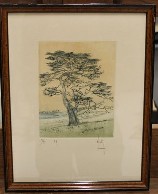 painting of a lone tree in a frame on a table