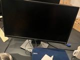 two computer monitors on a desk with a mouse and a mouse pad