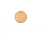 a gold coin on a white surface with a white background